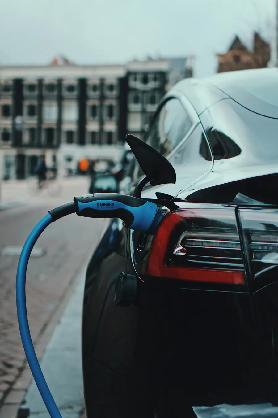 Close-up of a Mennekes Type 2 charging cable plugged into an EV
